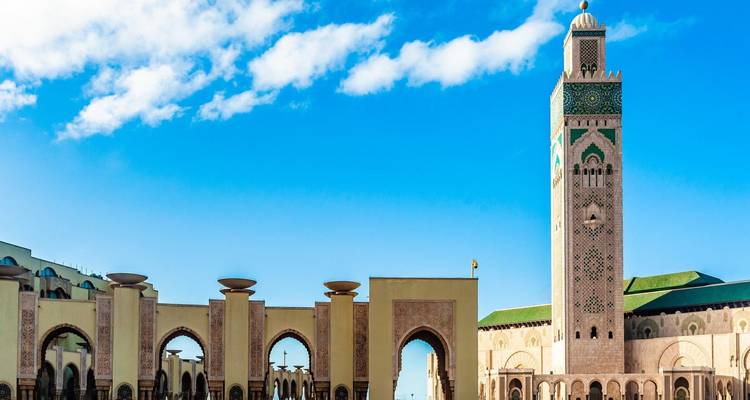 Hassan II Mosque minaret and arches under vibrant blue sky in Casablanca