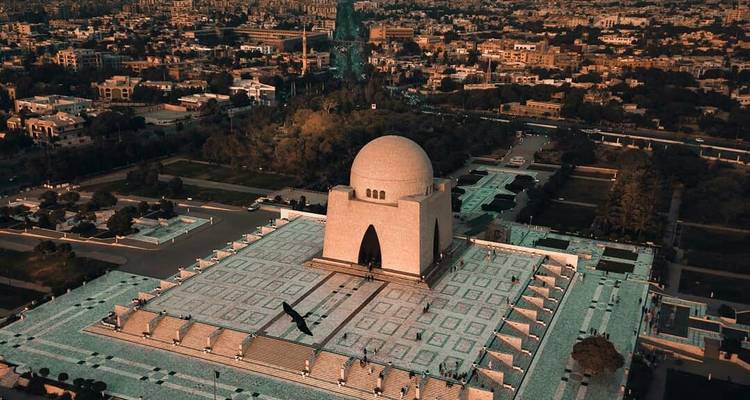 Aerial sunset view of Mazar-e-Quaid surrounded by the cityscape of Karachi