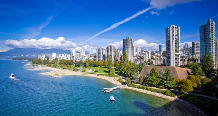 Bright summer view of Vancouver’s beachfront park, marina and distant mountains.