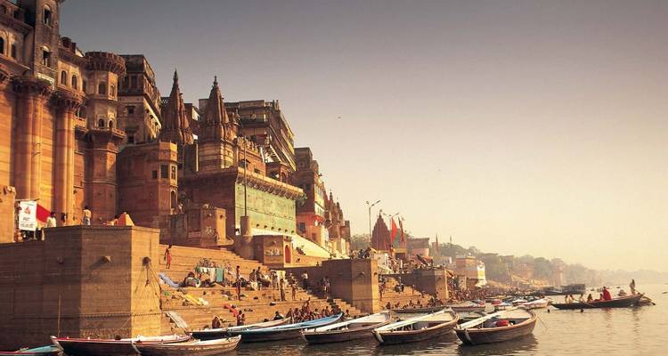 Historic ghats of Varanasi lined with temples and steps leading to the Ganges, crowded with boats and pilgrims.