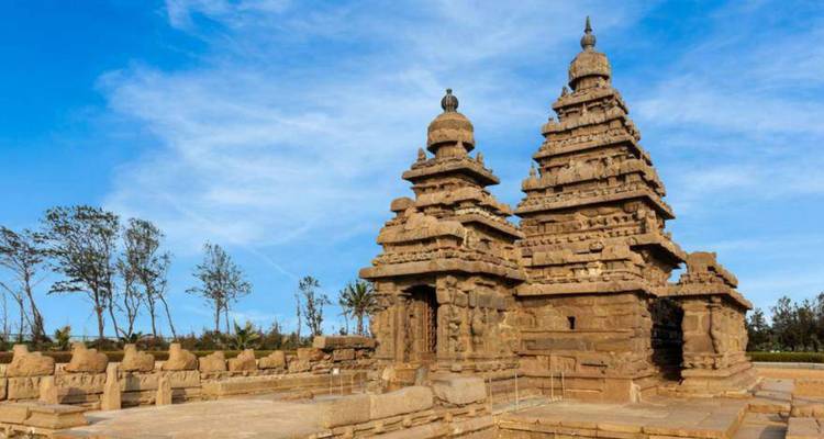 Le temple du rivage en granit aux tours jumelles se dresse contre un ciel côtier d'un bleu éclatant