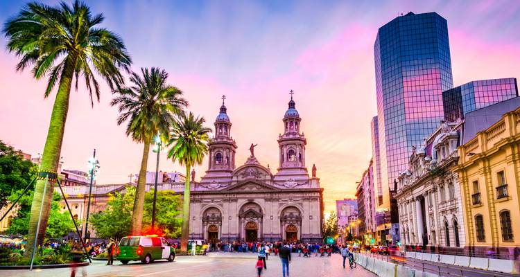 Vibrant sunset sky above Plaza de Armas and Metropolitan Cathedral in Santiago, Chile.