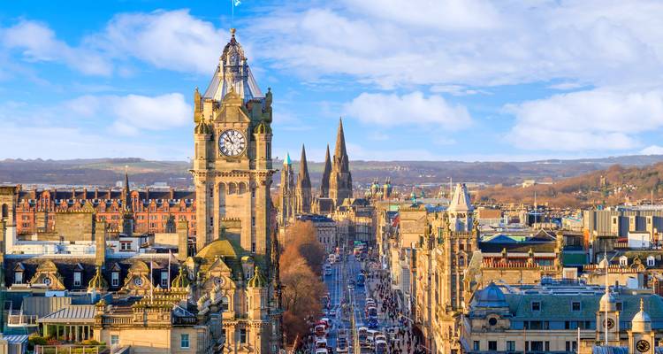 Elevated cityscape of Edinburgh with Balmoral clock tower and distant spires along Princes Street
