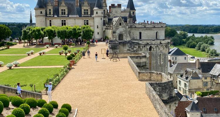 Elevated esplanade beside Château d’Amboise with tourists enjoying views over the Loire River and town below.