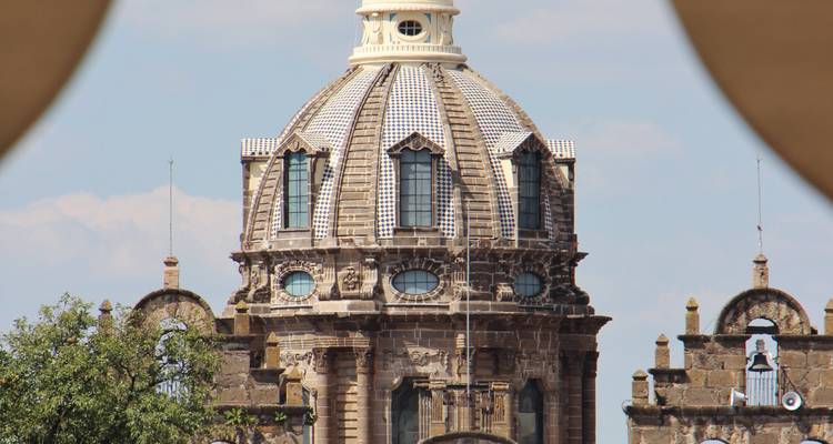 Vue rapprochée d'un dôme de cathédrale orné encadré par des formes d'arcs flous.