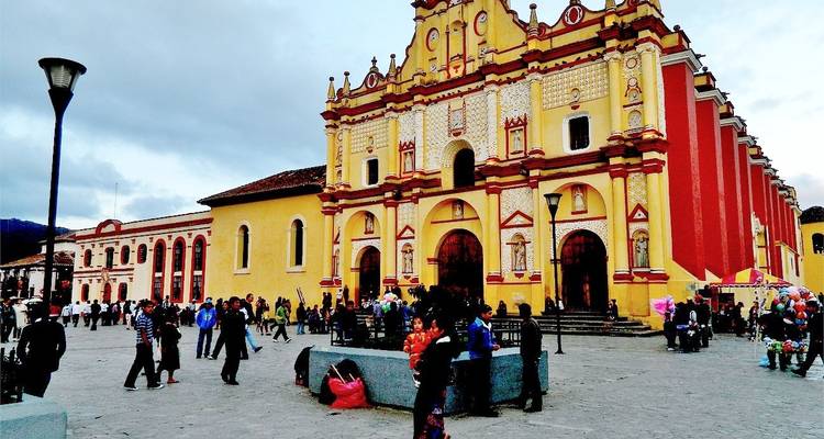 Vibrante catedral amarilla de San Cristóbal de las Casas dominando una plaza del pueblo llena de actividad