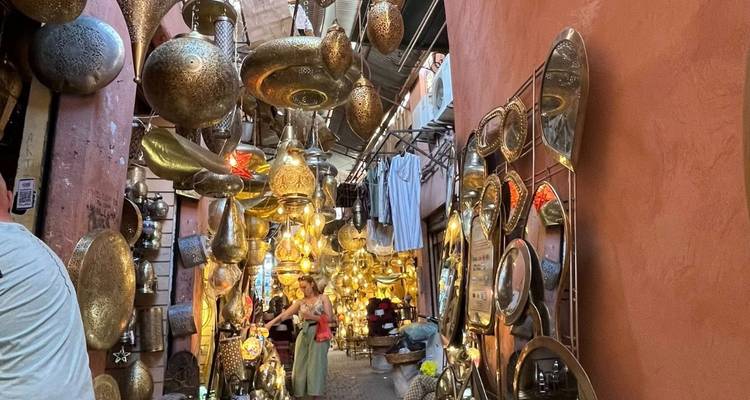 Atmospheric Marrakesh souk corridor filled with hanging brass lamps and glowing lanterns.