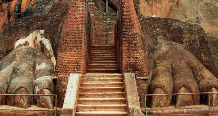 Massive brick lion-paw staircase carved into rock at Sigiriya archaeological site.