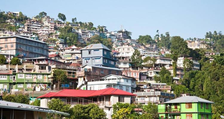 Ville de colline densément peuplée avec des maisons colorées empilées le long de la pente.