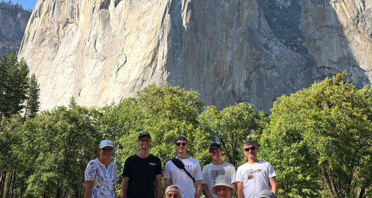 Foto grupal con la escarpada cara de granito de El Capitan elevándose detrás en el Valle de Yosemite.