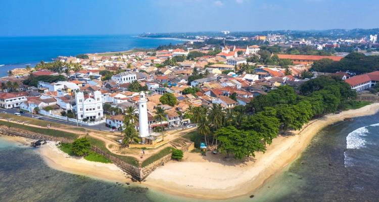 Aerial view of historic Galle Fort peninsula, lighthouse and surrounding turquoise sea and beaches.