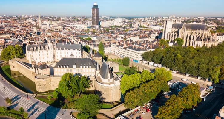 Aerial view of Nantes showing the Château des Ducs de Bretagne, cathedral and city skyline.
