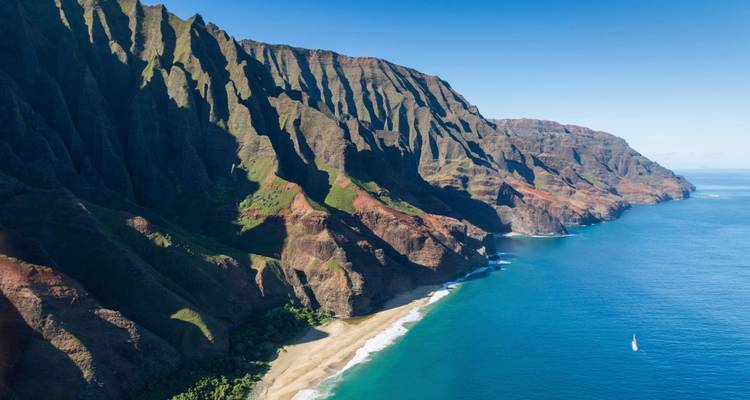 Lang stuk van de ruige Nā Pali zeekliffen die afzakken naar helderblauwe water.