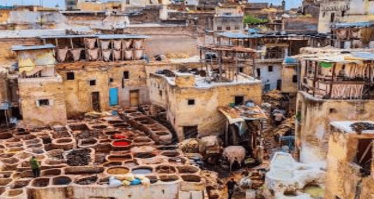 Aerial view of Fes tannery with colorful dye pits and ancient buildings.