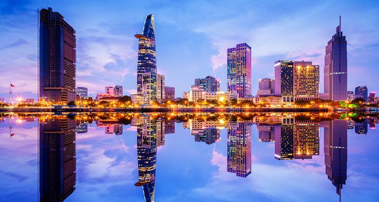Schemering panorama van de skyline van Ho Chi Minh-Stad perfect weerspiegeld in het stille rivierwater.