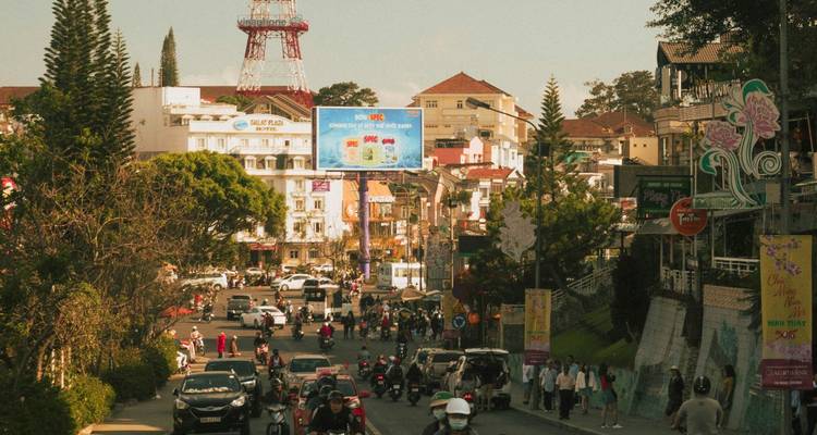 Busy afternoon street in mountainous Dalat with traffic and pedestrians