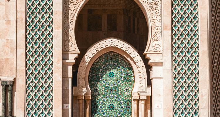 Close-up of ornate archway and green mosaic door at Hassan II Mosque.