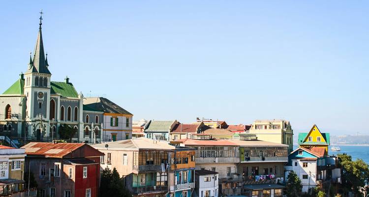 Colourful hillside houses and church spire overlook the Pacific in Valparaiso.