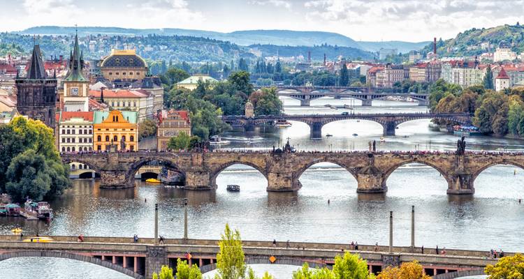 Panoramique urbain de Prague avec plusieurs ponts historiques enjambant la rivière Vltava.