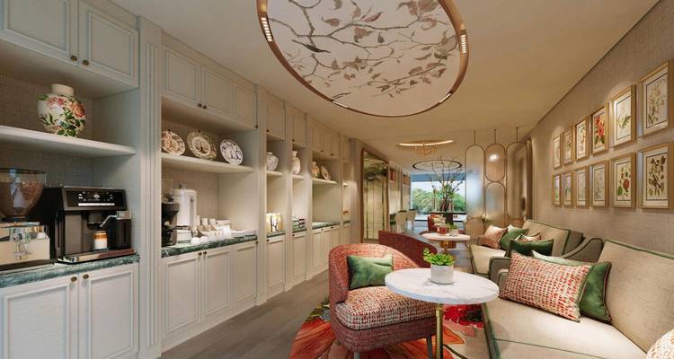 Un élégant salon à bord orné de meubles crème, d'un panneau de plafond fleuri et de sièges moelleux invite les clients à se détendre.