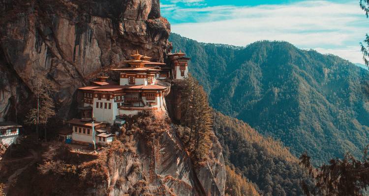 Iconic cliff-side Tiger's Nest monastery perched dramatically above a deep forested valley