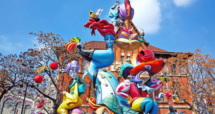 Vibrant papier-mâché sculptures during Valencia’s Las Fallas festival under blue skies