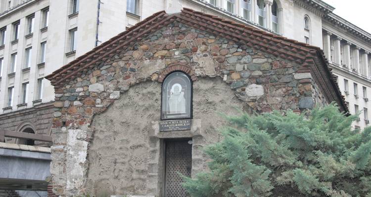 Petite église médiévale en pierre de Sainte-Pétka nichée parmi des bâtiments modernes