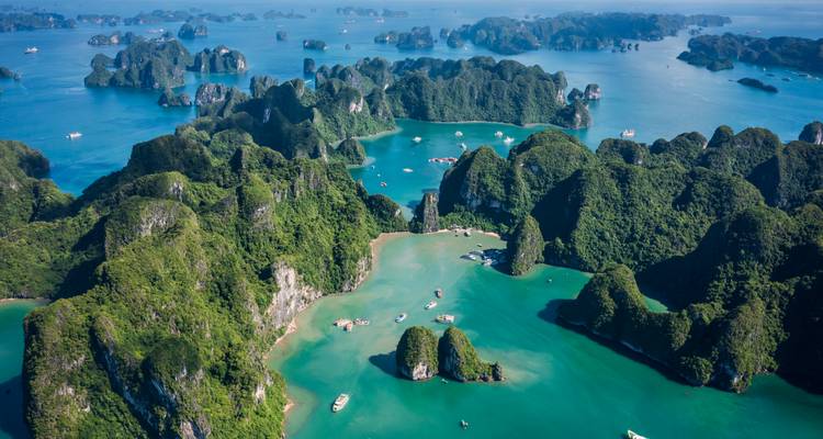 Vista aérea de bahías turquesas e islas de piedra caliza exuberantes dispersas por el mar.