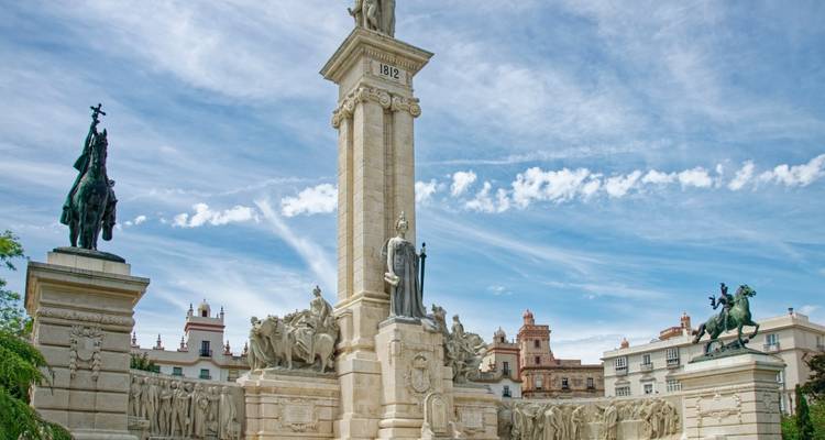 Monumento de la Constitución Neoclásica de 1812 en la soleada plaza de Cádiz con cielo azul de fondo