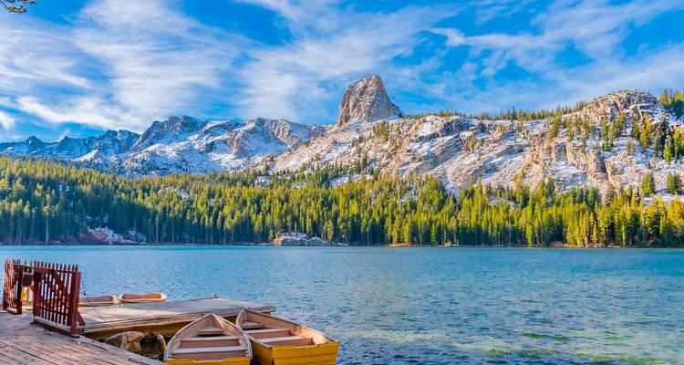 Kristalhelder alpien meer omgeven door sneeuwbedekte pieken en dicht naaldbos in de buurt van Mammoth Lakes.