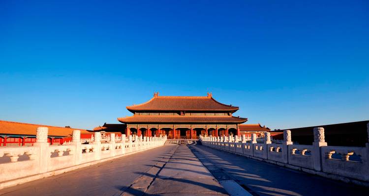 The Hall of Supreme Harmony in Beijing’s Forbidden City bathed in warm sunrise light with a clear cobalt sky overhead.