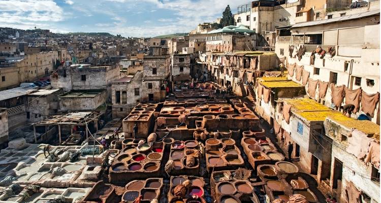 High-angle view of the tannery pits and old city rooftops of Fes, Morocco.