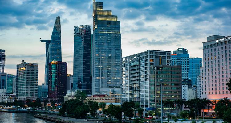 Modern skyline of Ho Chi Minh City featuring the Bitexco Tower at dusk.