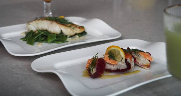 Elegant plated seafood and vegetable dishes on a restaurant table