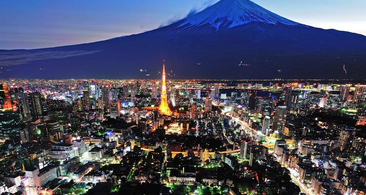 Dramatisch nachtelijk uitzicht op verlichte Tokyose straten onder de dreigende silhouet van de berg Fuji.