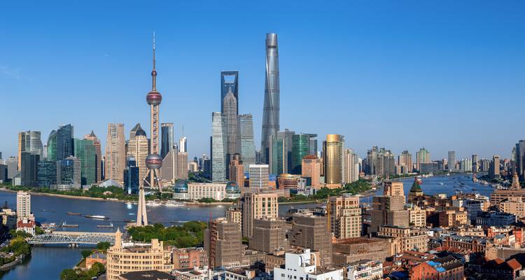 Daytime view of Shanghai’s Lujiazui skyline with iconic towers under clear blue sky
