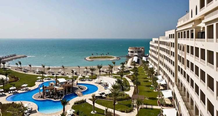 Seaside resort with pools, palm-lined gardens and a sweeping view of the blue gulf.