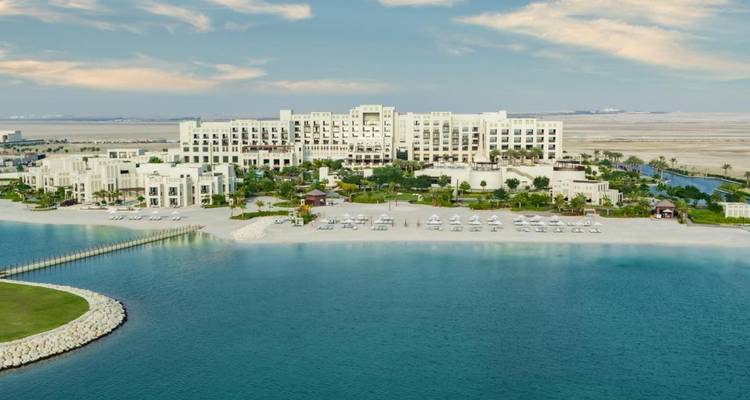 Grand beachfront resort complex facing tranquil blue gulf waters.