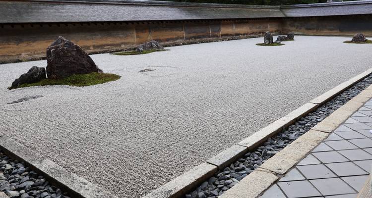Zen rock garden at Ryoan-ji with raked gravel and island stones