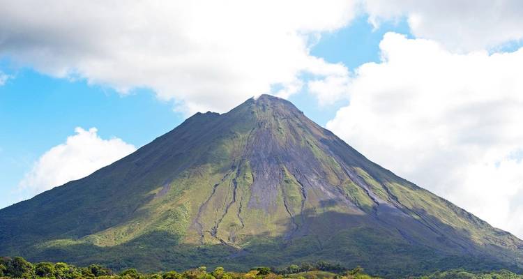 Repetition image of Arenal Volcano with lush greenery below.