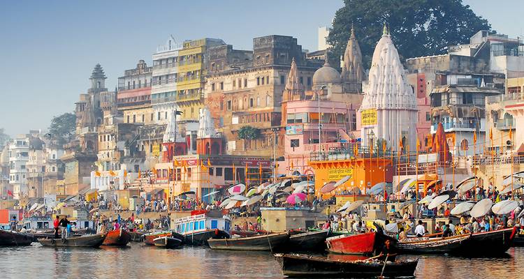 De kleurrijke ghats van Varanasi liggen langs de Ganges met boten die druk langs de levendige oever worden vervoerd.