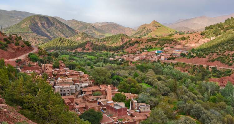 Small Berber village nestled among terraced hills and green valleys of the Atlas foothills.