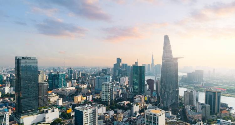 Panoramic skyline of Ho Chi Minh City with Bitexco Tower and Saigon River at sunrise