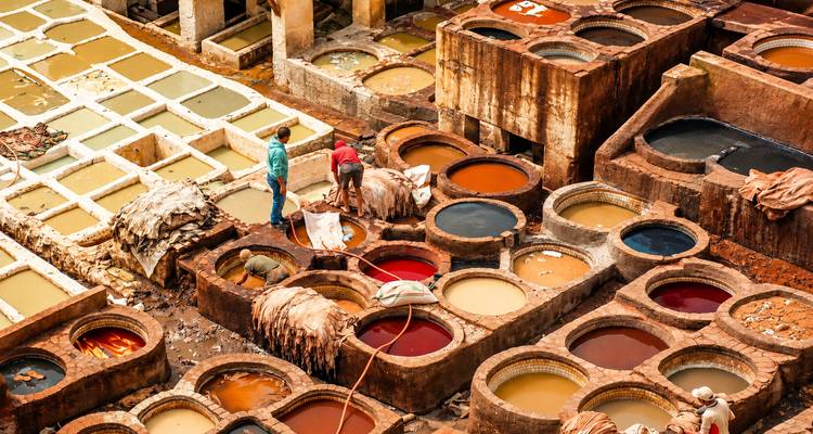 Trabajadores cuidando cubas de tintes de colores en las famosas curtidurias de cuero de Fez.