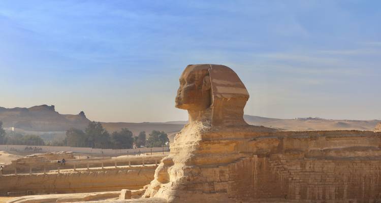Iconic Great Sphinx of Giza profile against a hazy blue desert sky
