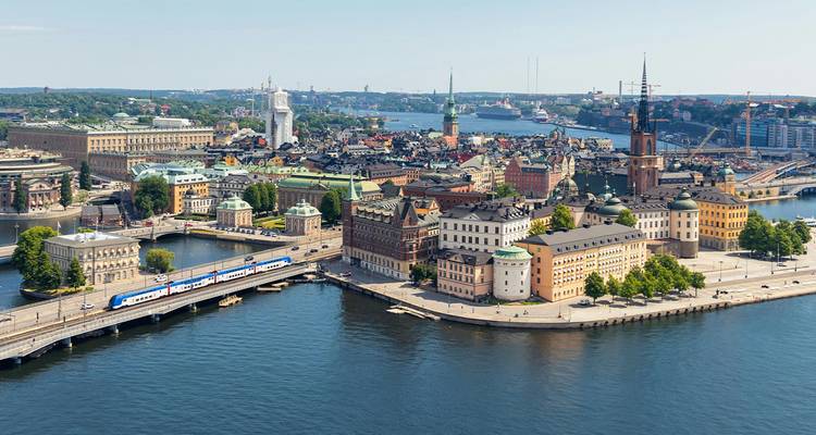 Aerial panorama of Stockholm’s historic Gamla Stan island surrounded by sparkling waterways and bridges.