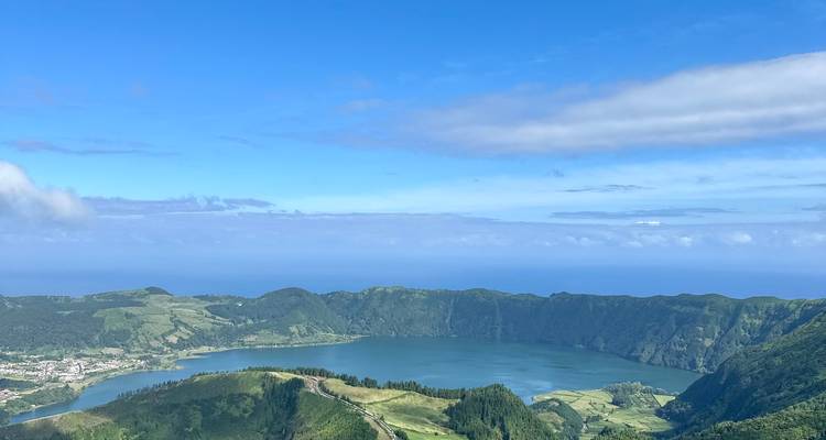 Panoramic view of Lagoa Azul within the Sete Cidades caldera under a clear blue sky.