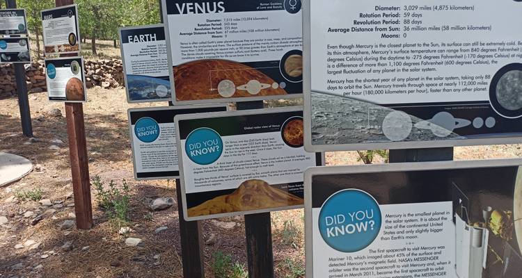 Outdoor educational trail lined with informational planet panels about the solar system.