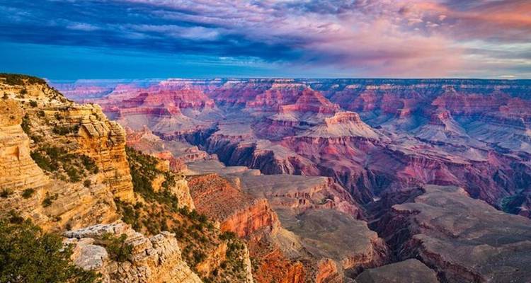 Les strates multicolores vibrantes du Grand Canyon illuminées sous des ciels dramatiques.