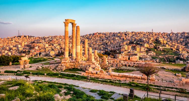 La lueur du coucher de soleil sur les colonnes du Temple d'Hercule dominant le vaste paysage urbain d'Amman et les collines ondulantes